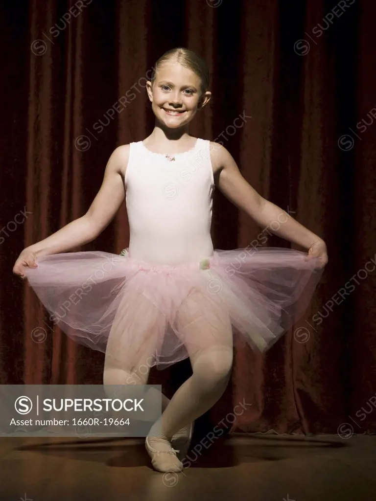 Ballerina girl on stage curtsying