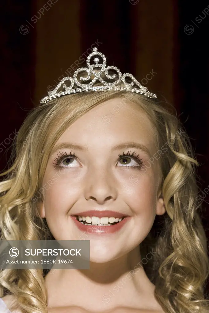 Closeup of girl with tiara looking up smiling