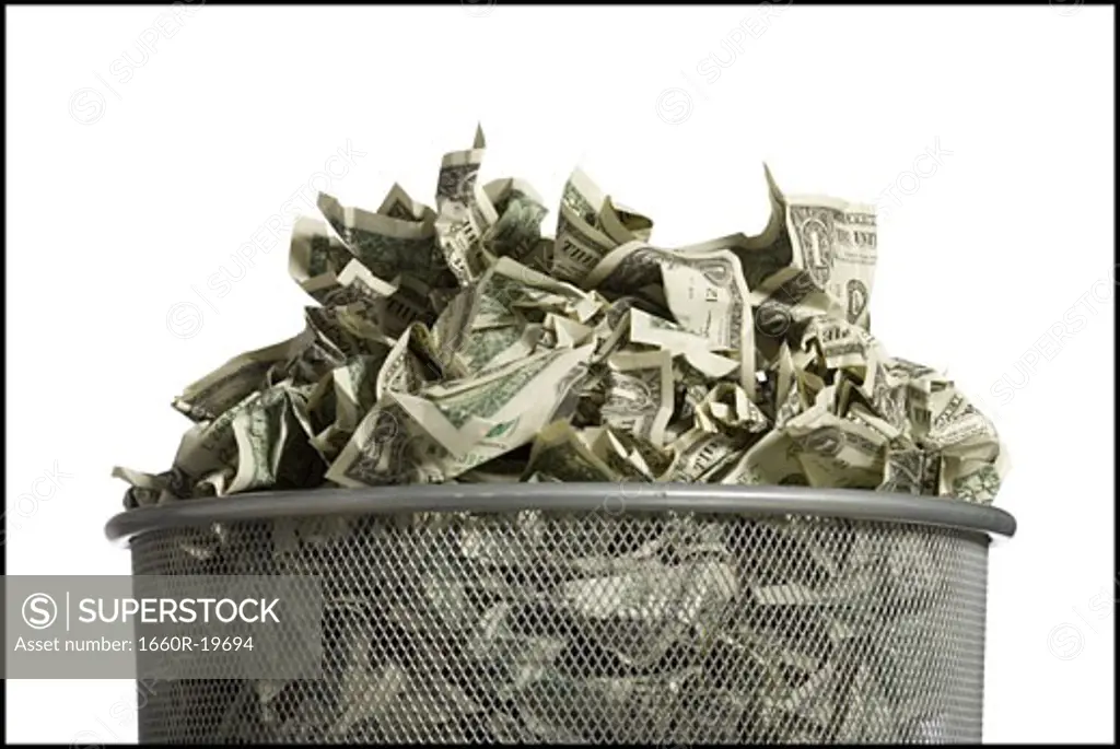 Waste paper basket with crumpled money
