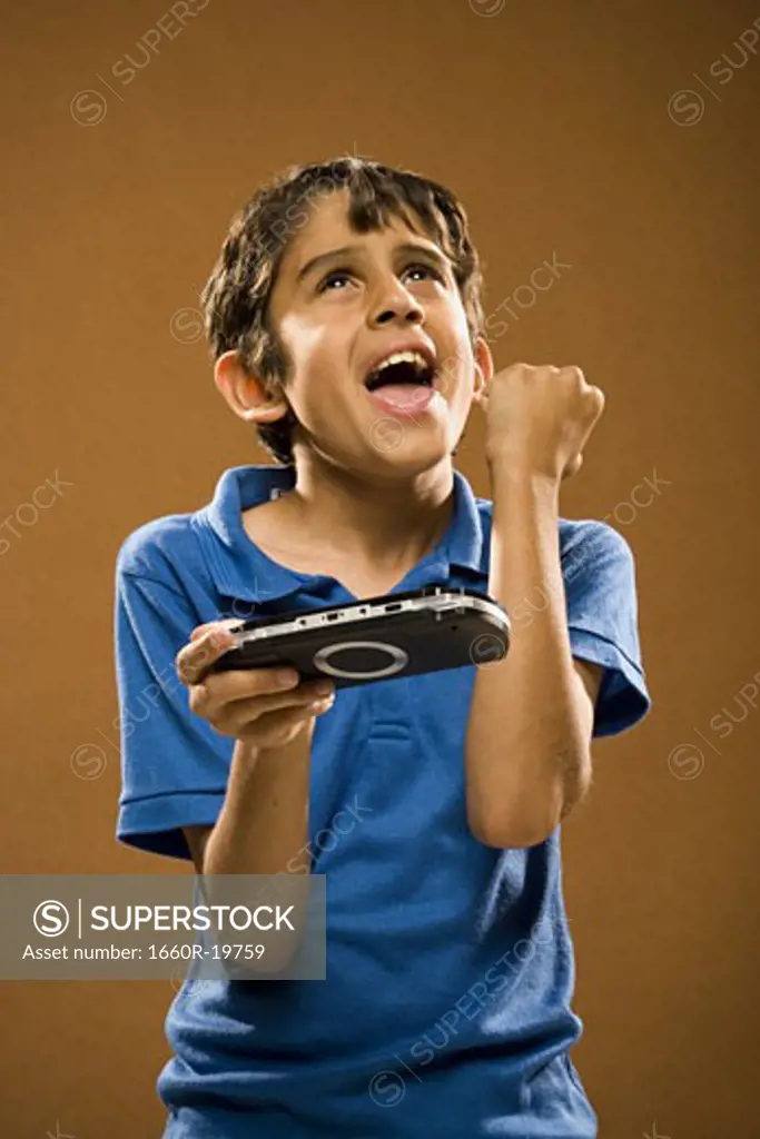 Boy holding video game cheering