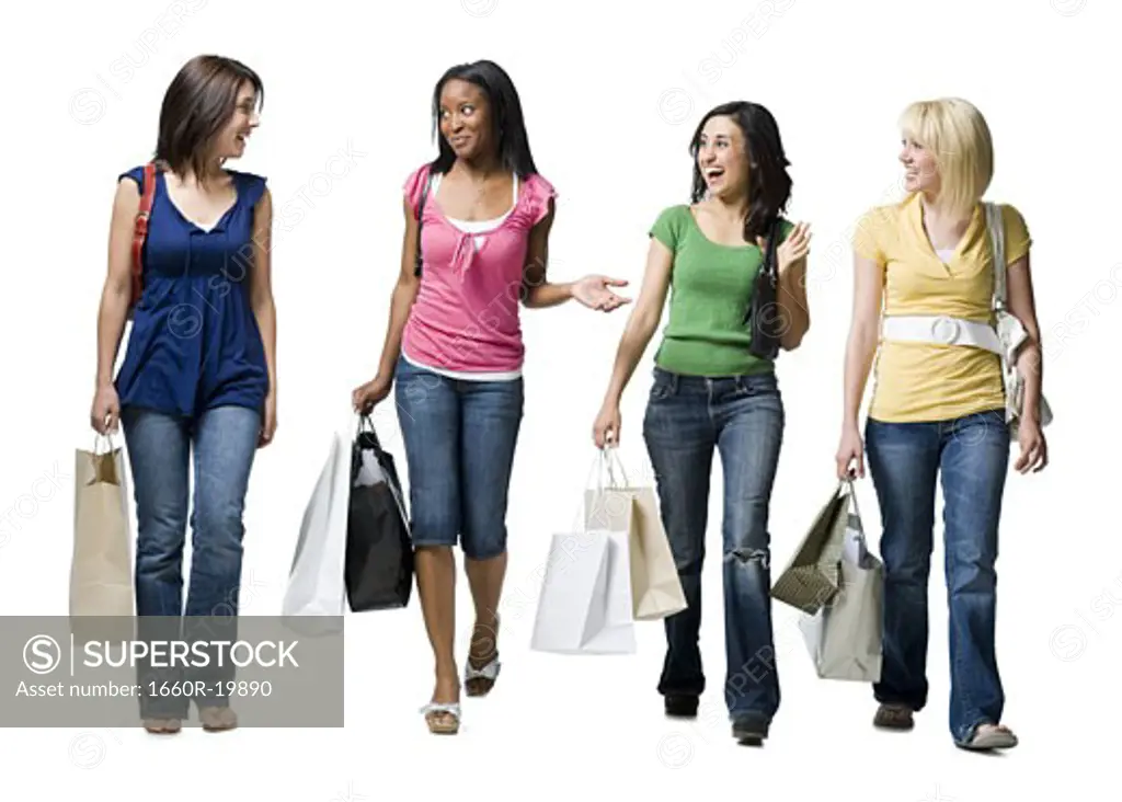 Four women with shopping bags smiling