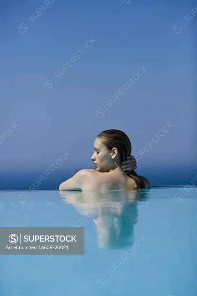 Profile of woman in pool outdoors