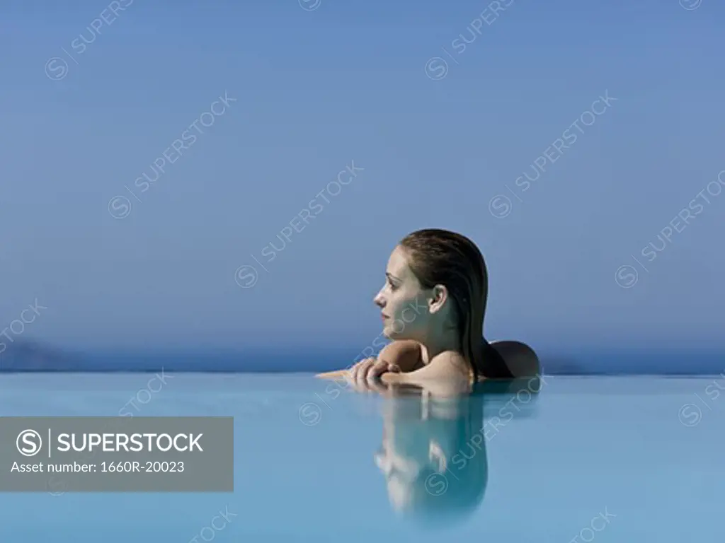 Woman in infinity pool reflection