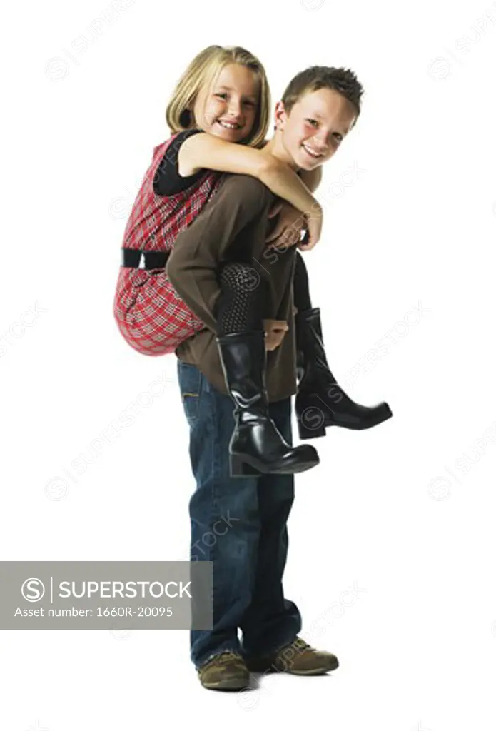 Boy giving girl piggy back ride smiling