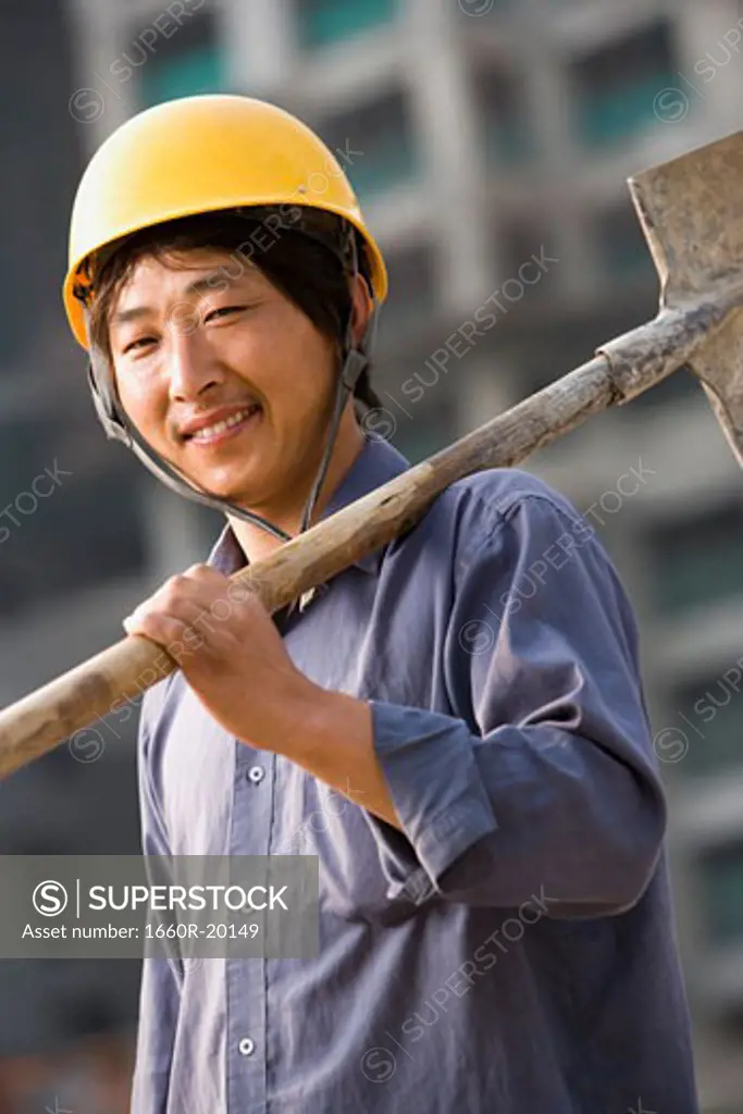 Construction worker outdoors with helmet smiling