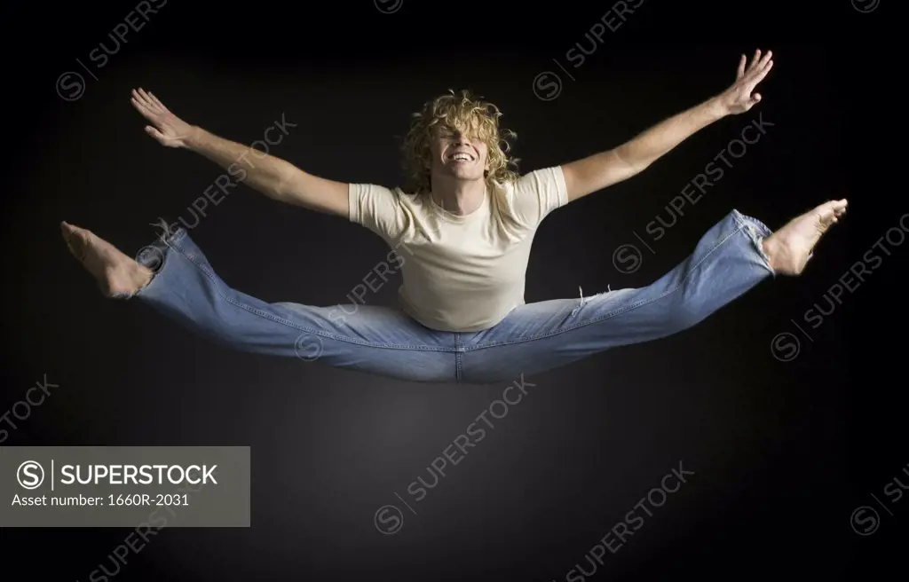 Young man doing splits in mid-air