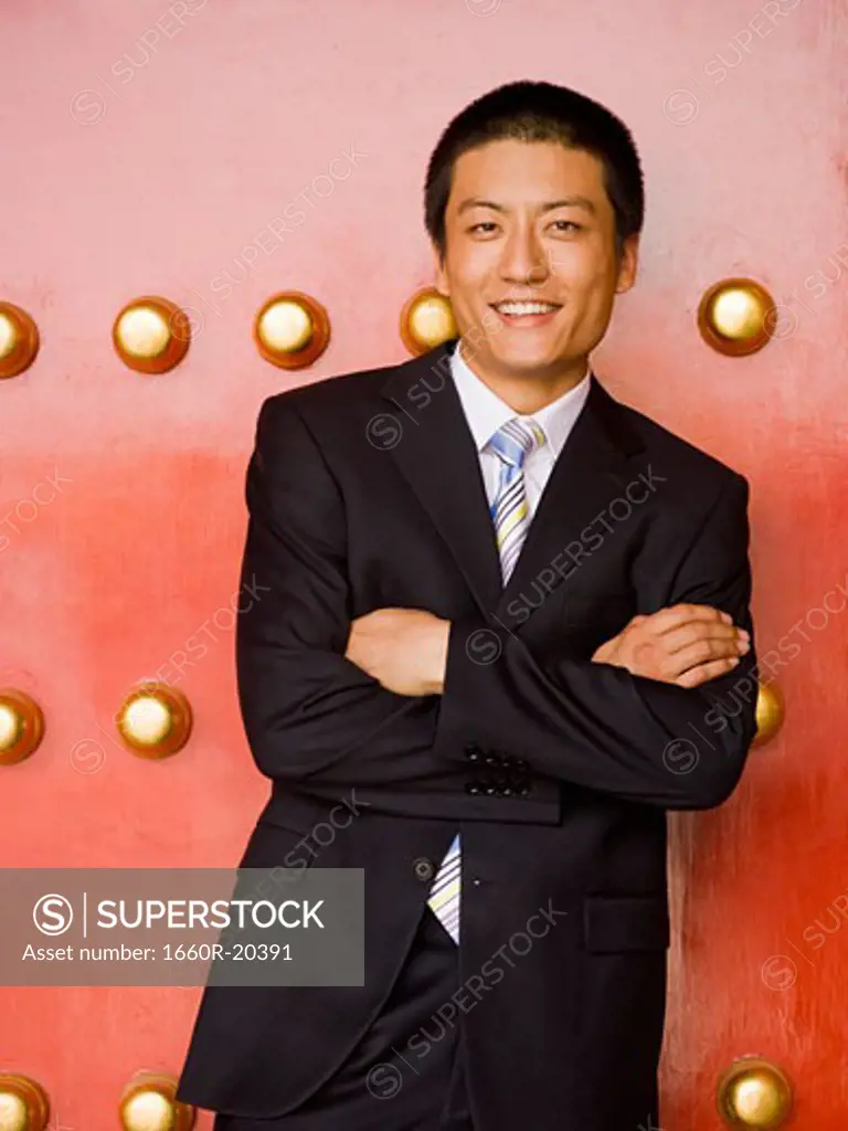 Portrait of a businessman with arms crossed smiling