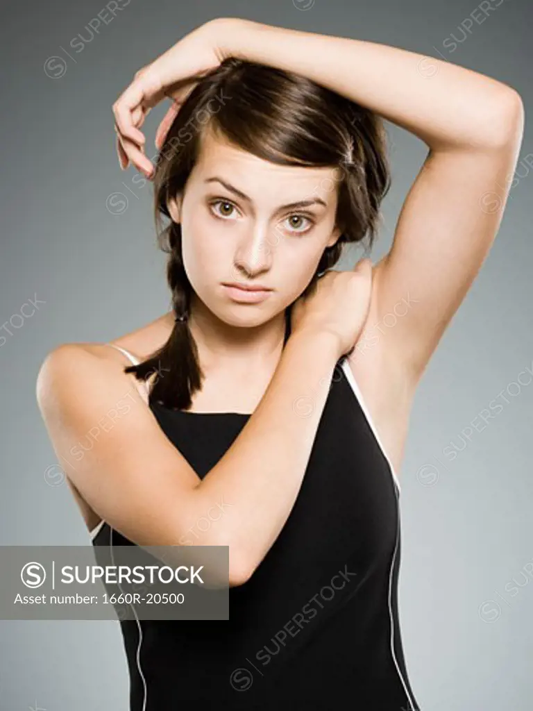 Teenage girl stretching arms