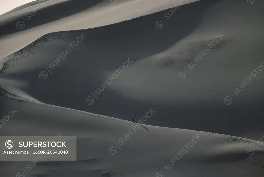 Person on large sand dunes