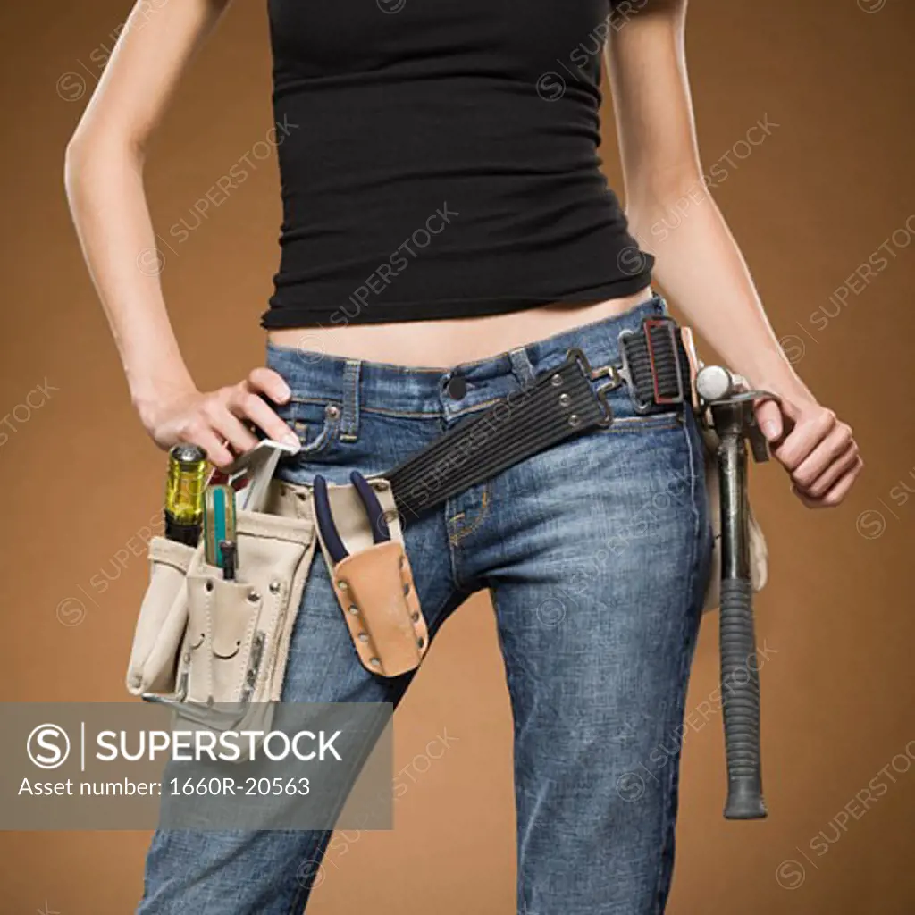 Mid section view of woman with tool belt