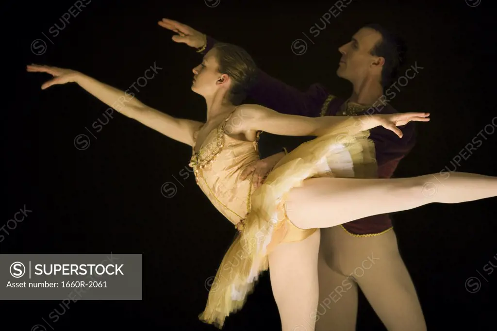 Male ballet dancer supporting a female ballerina