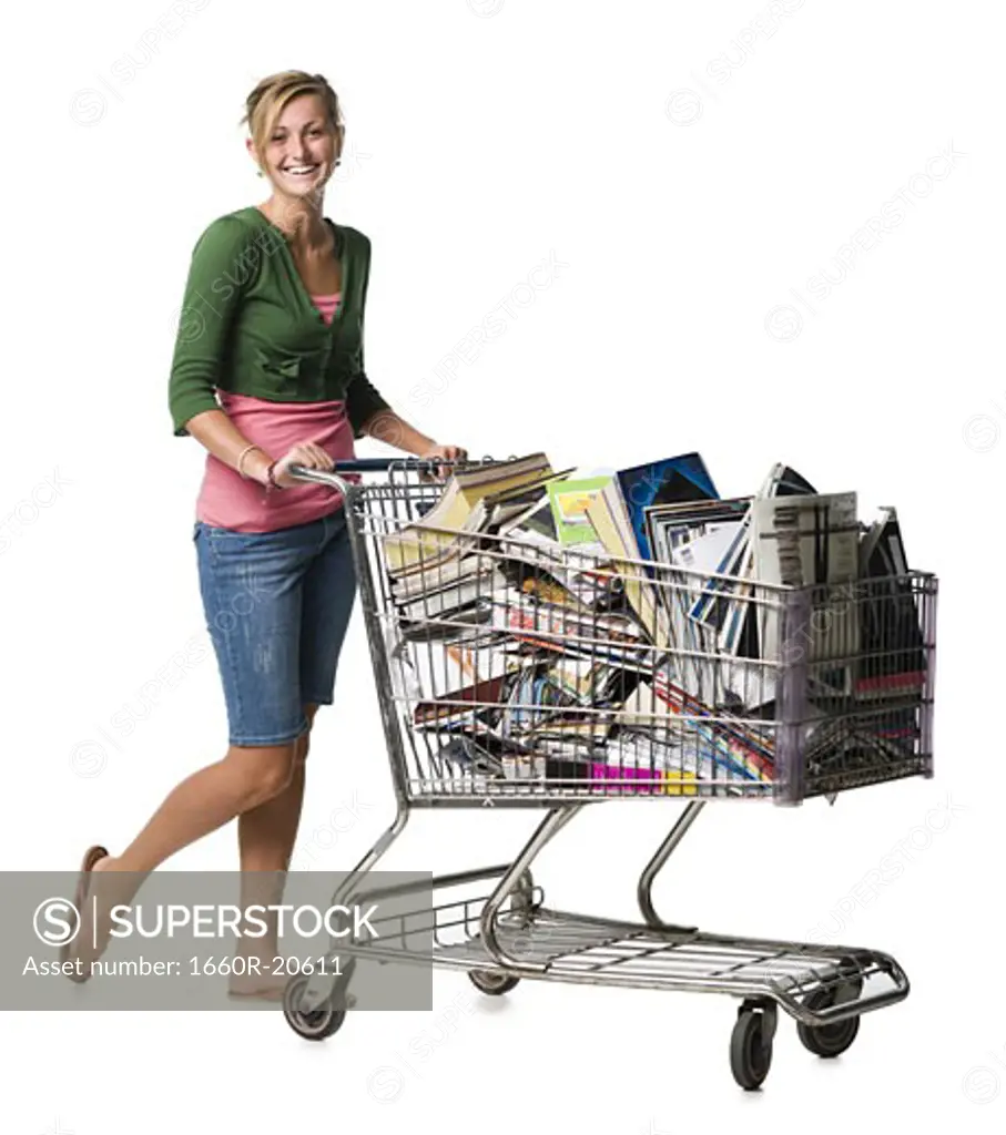 Woman with shopping cart filled with books smiling