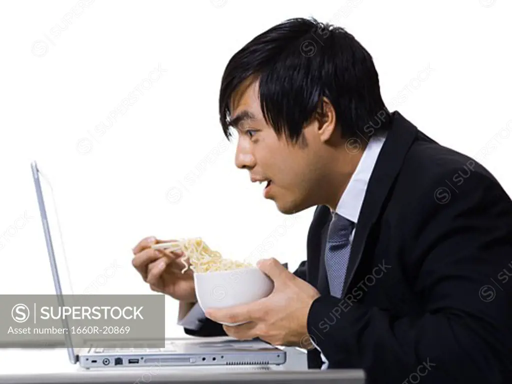 Man eating with laptop