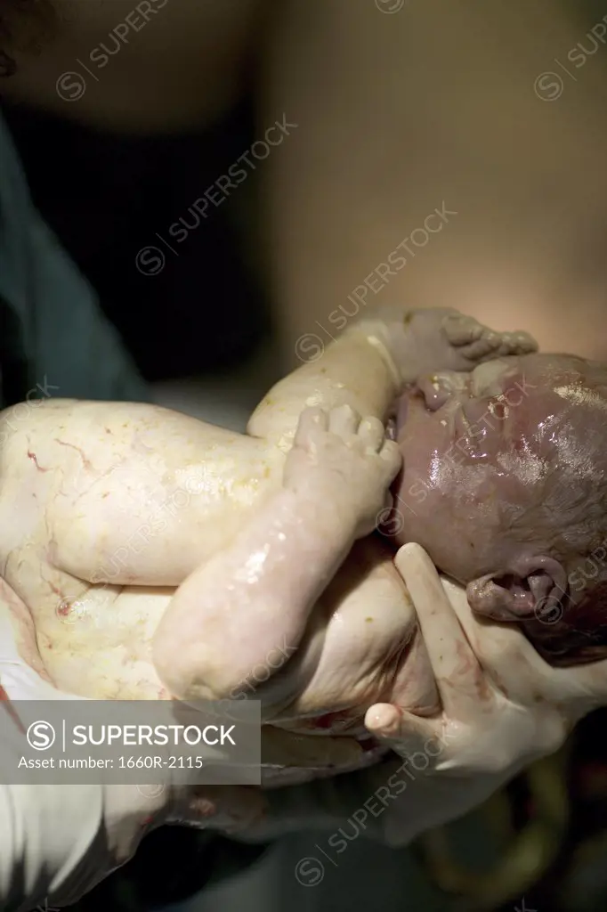 Person carrying a newborn baby