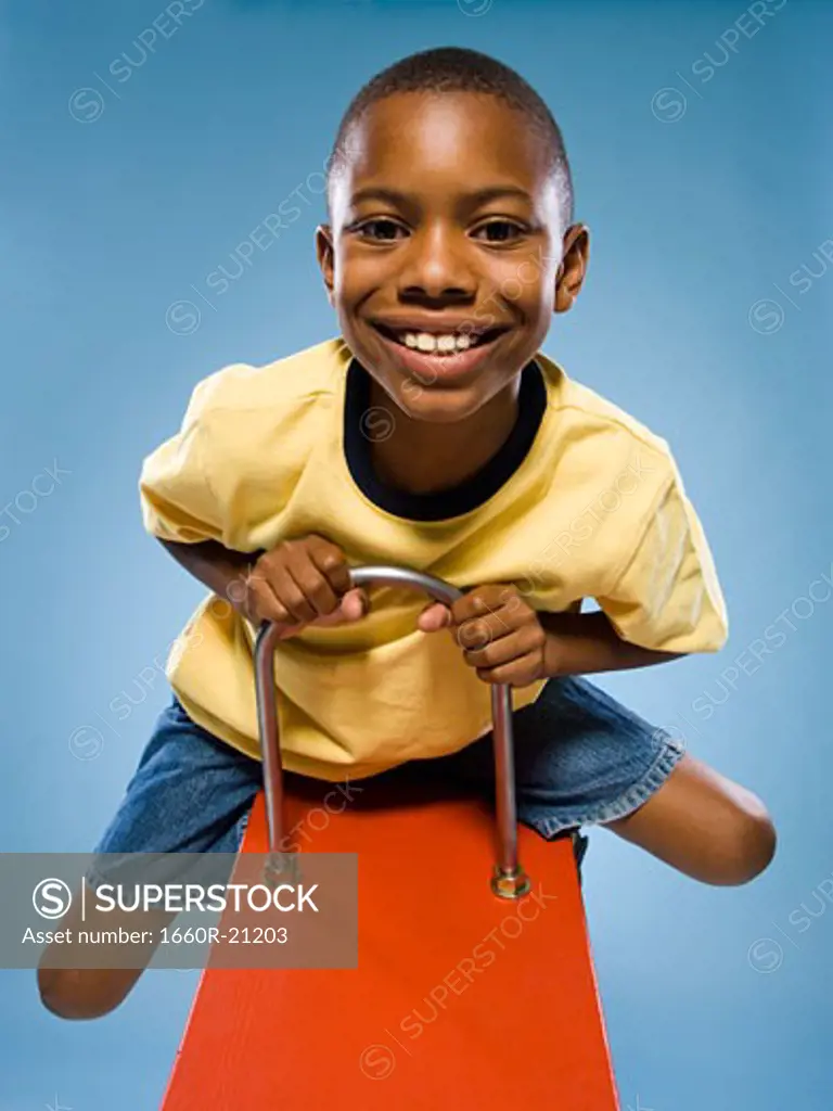 Child riding on a see saw.