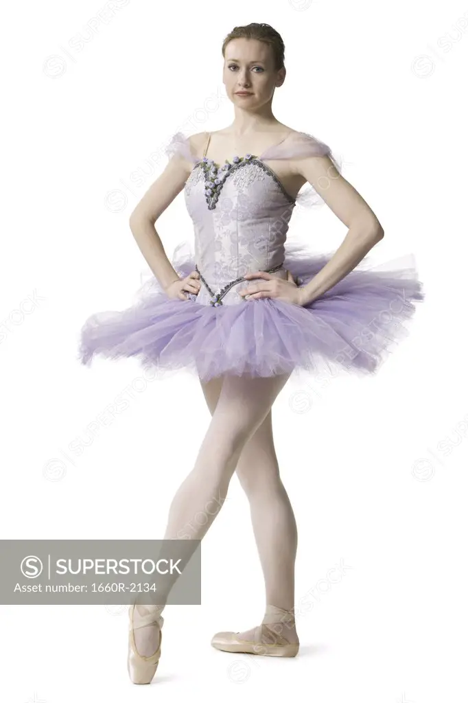 Ballerina standing with arms akimbo