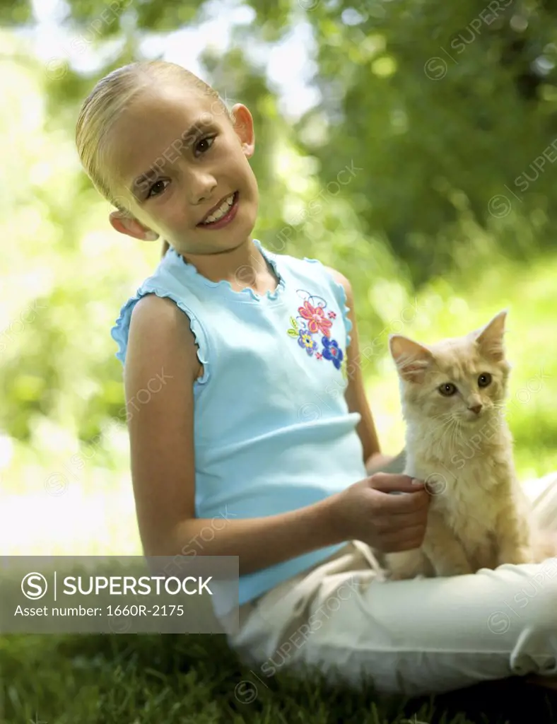 Portrait of a girl sitting with a kitten