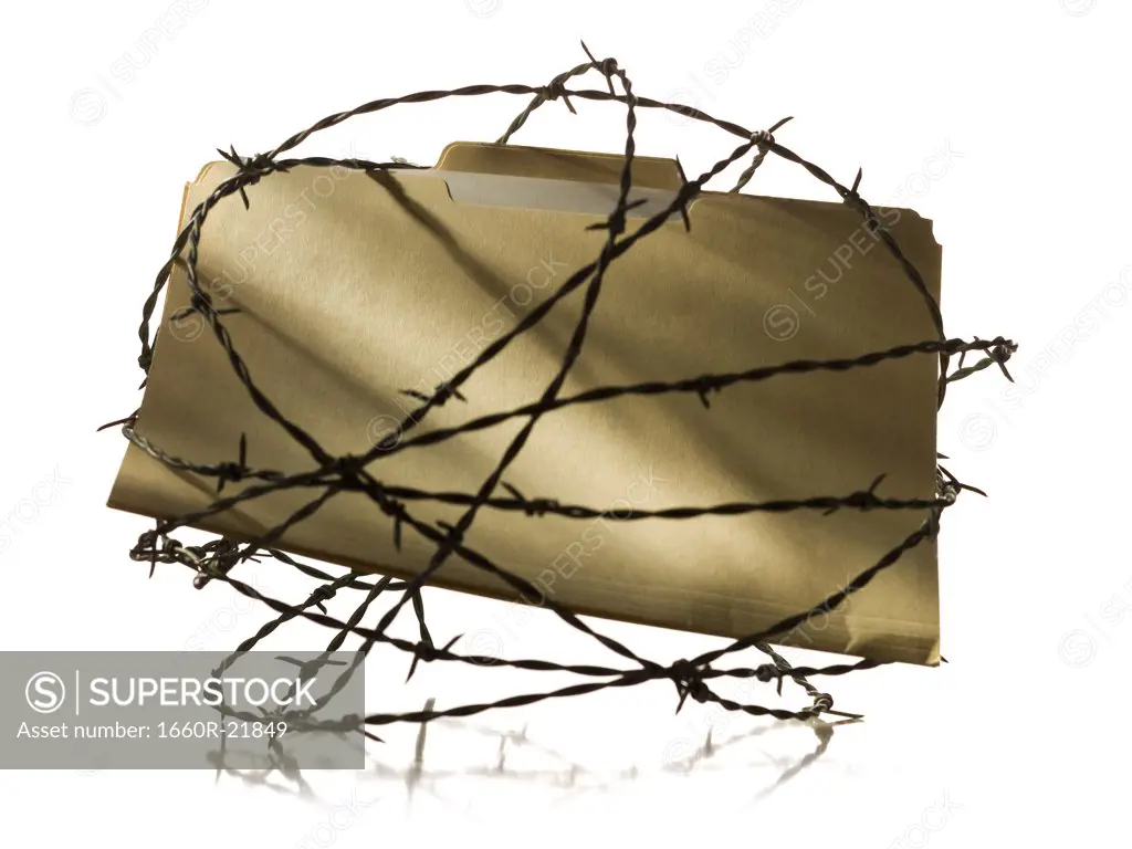Manila file folder surrounded by barbed wire.