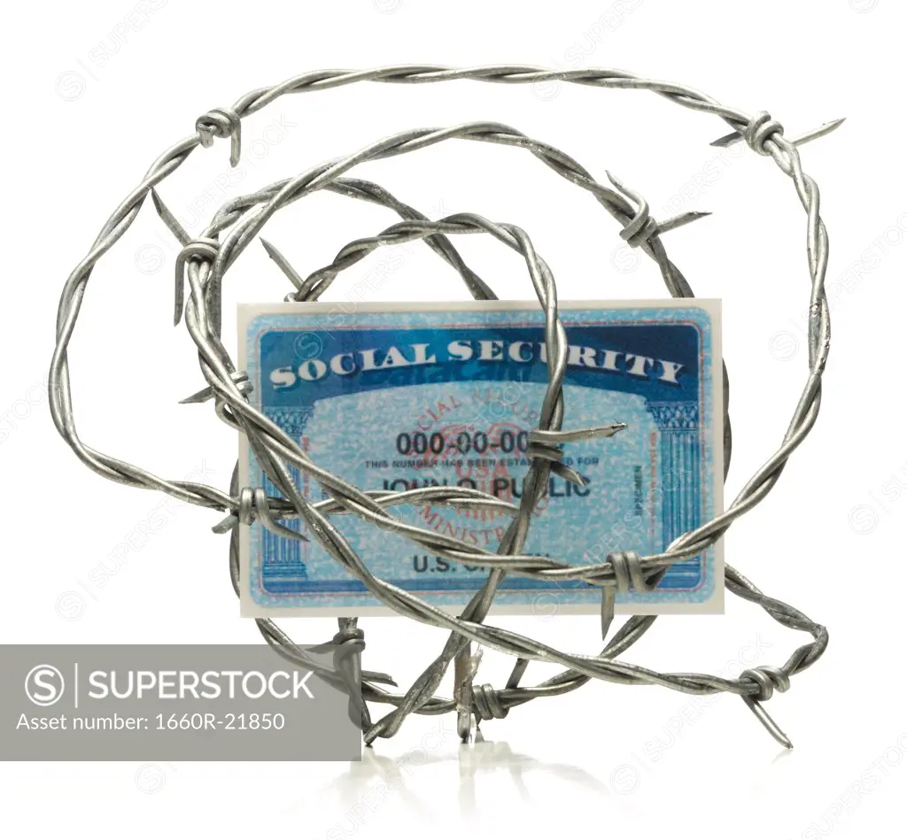 Social security card surrounded by barbed wire.