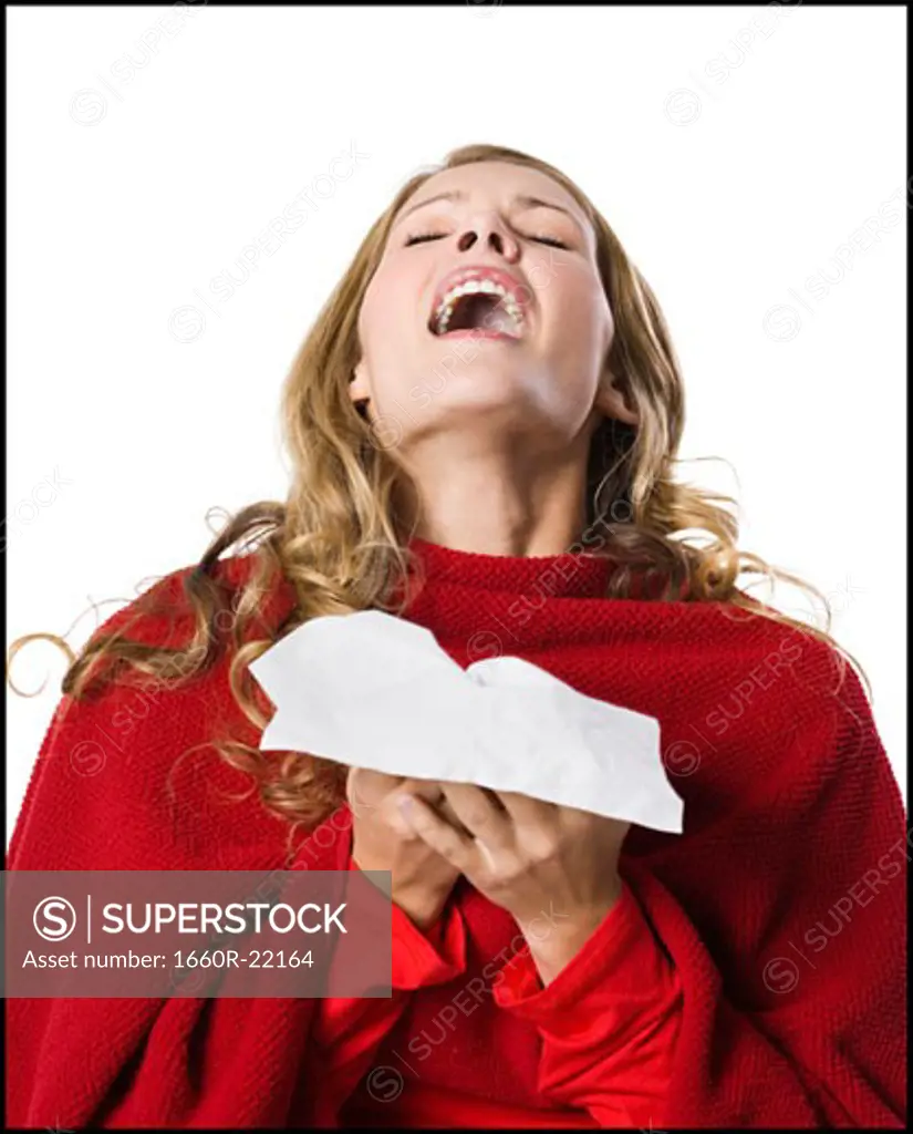 young woman sneezing.