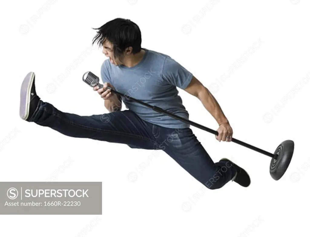 Man rocking out with mic stand.