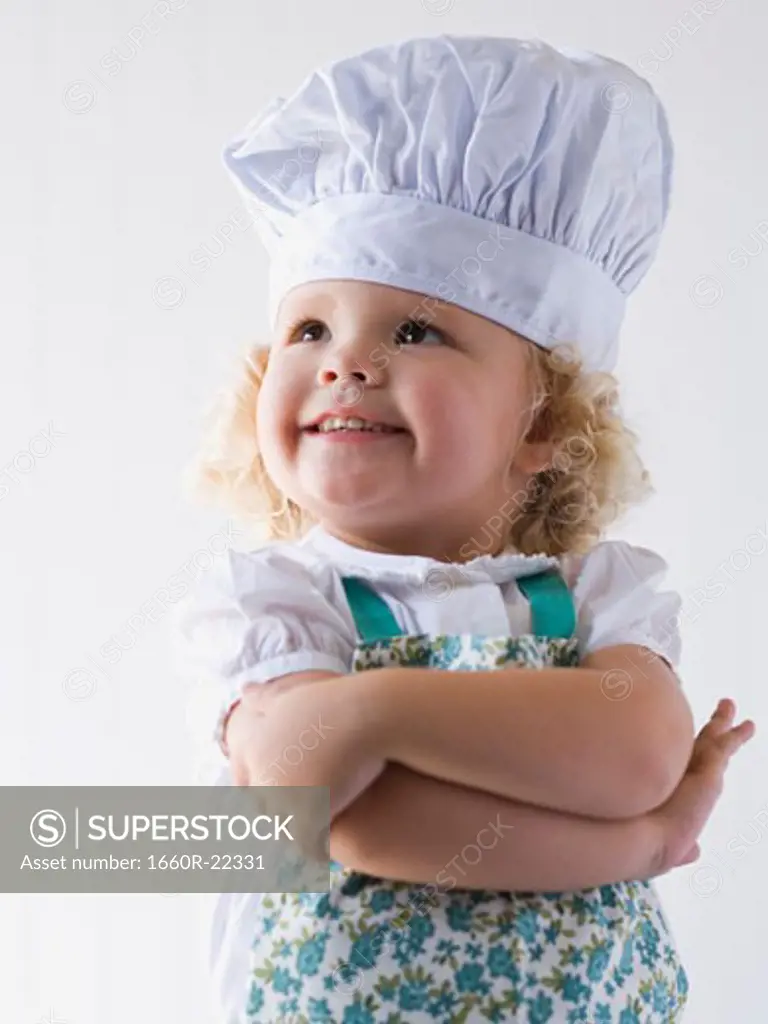 little girl with a chef's hat on.