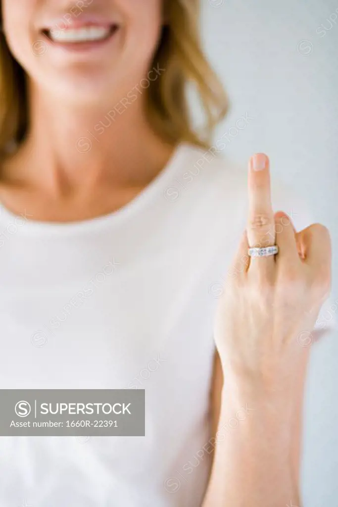 Woman holding up her wedding ring.