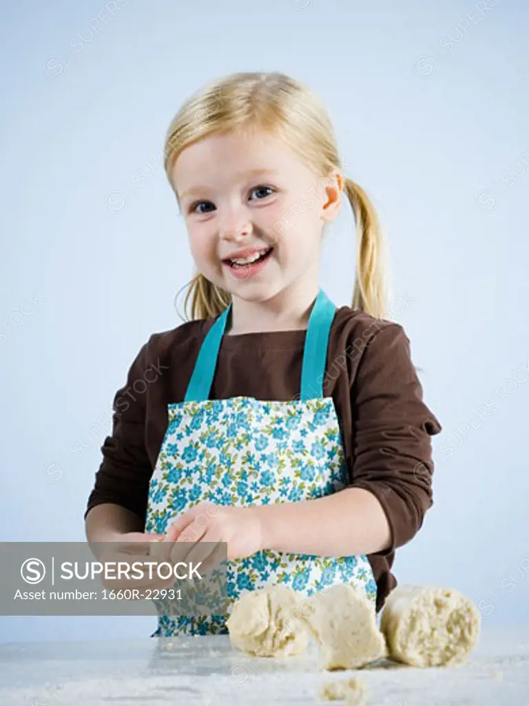 little girl kneading dough