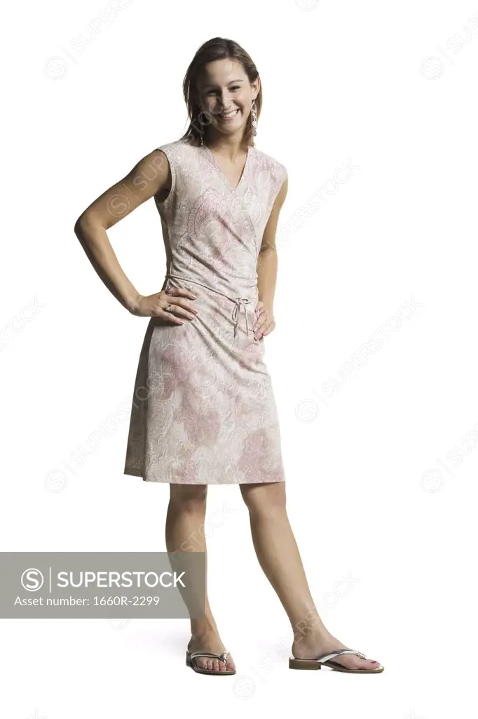 Portrait of a young woman standing with arm akimbo
