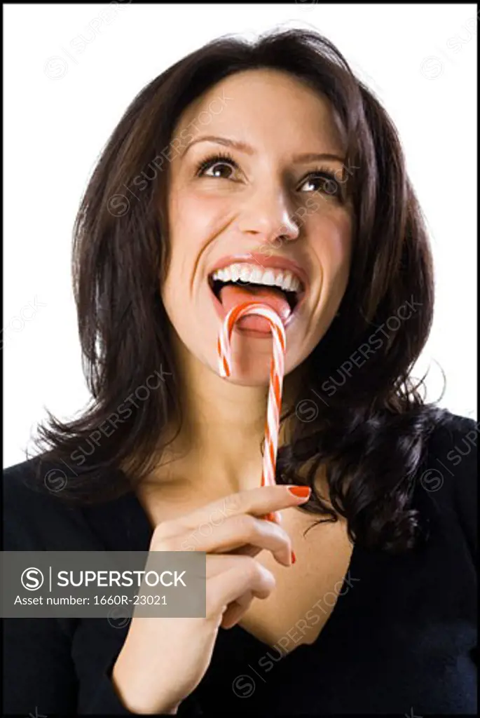 woman licking a candy cane