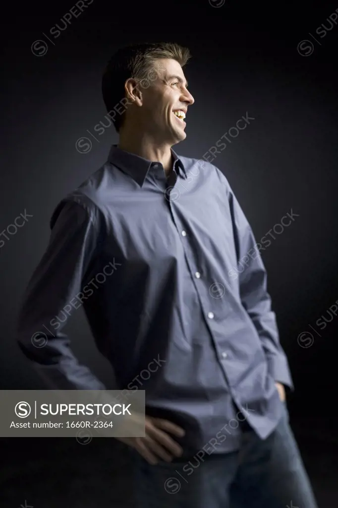 Mid adult man standing with his hands on his hips