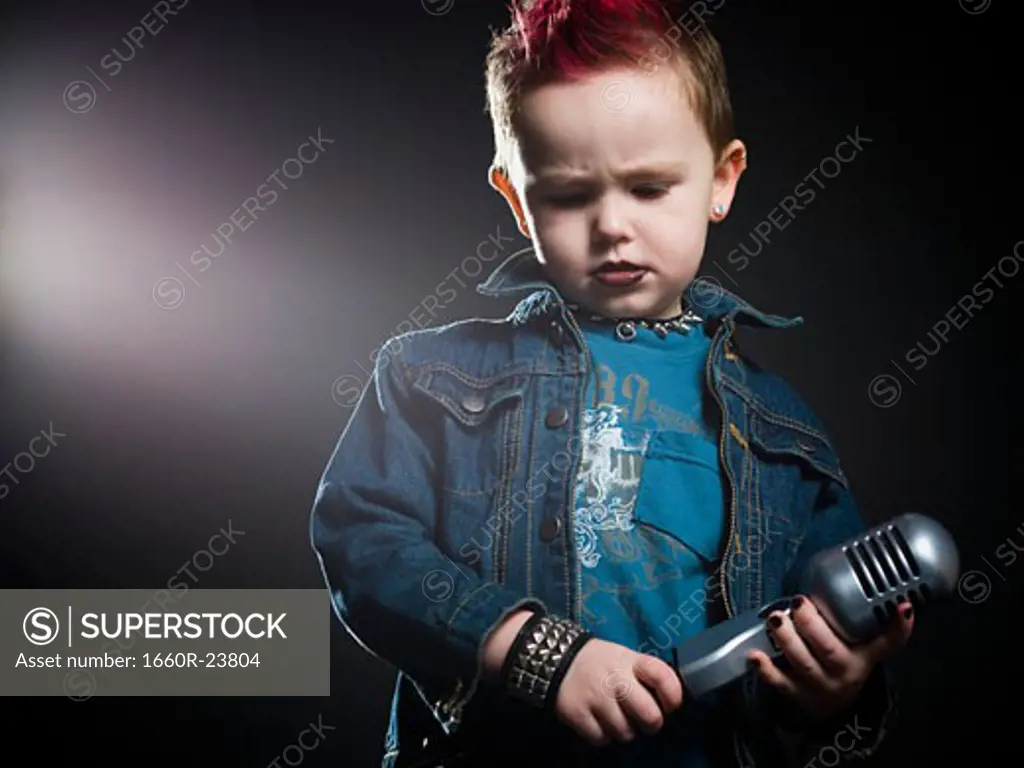 little boy singing into a microphone