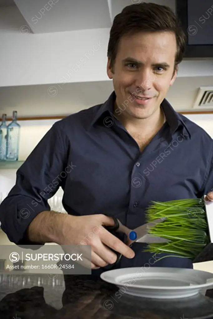 Portrait of a man cutting wheatgrass