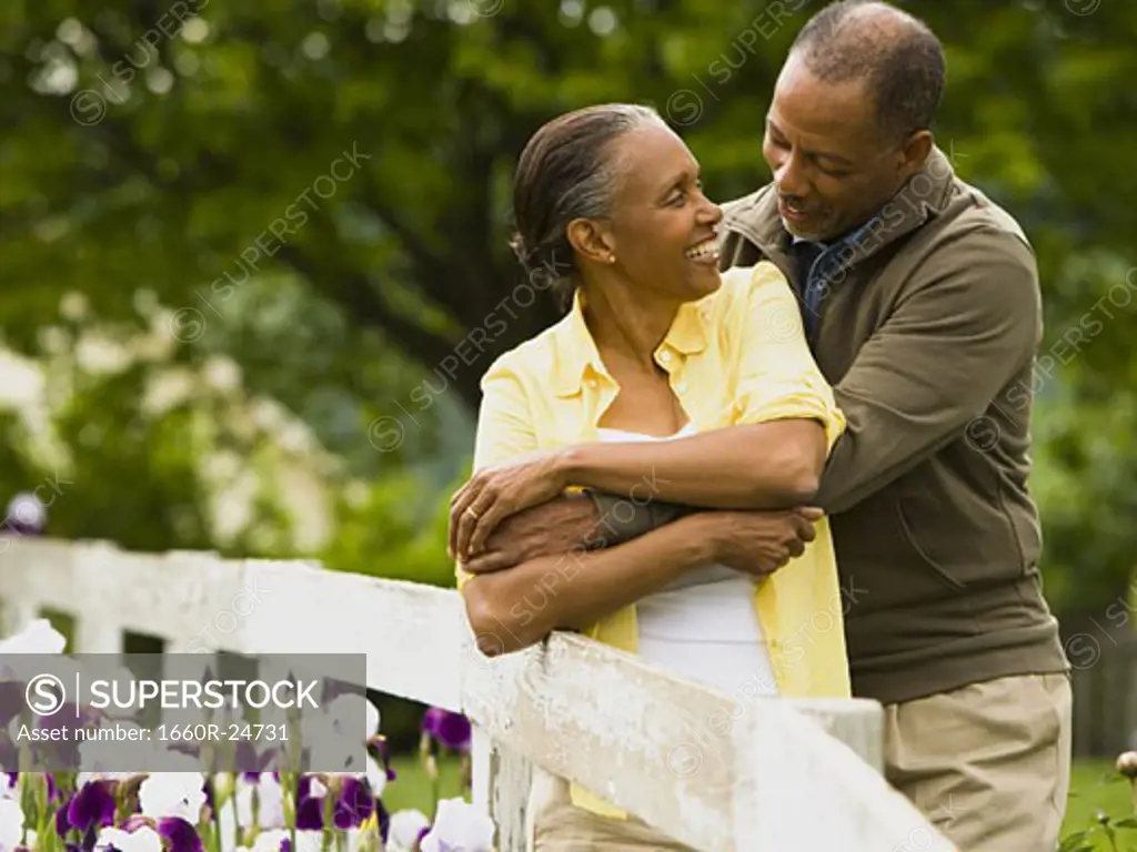 Senior man embracing a senior woman from behind