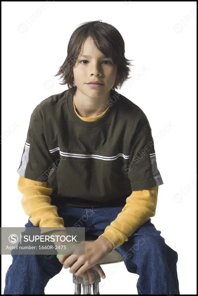 Portrait of a boy sitting on a stool