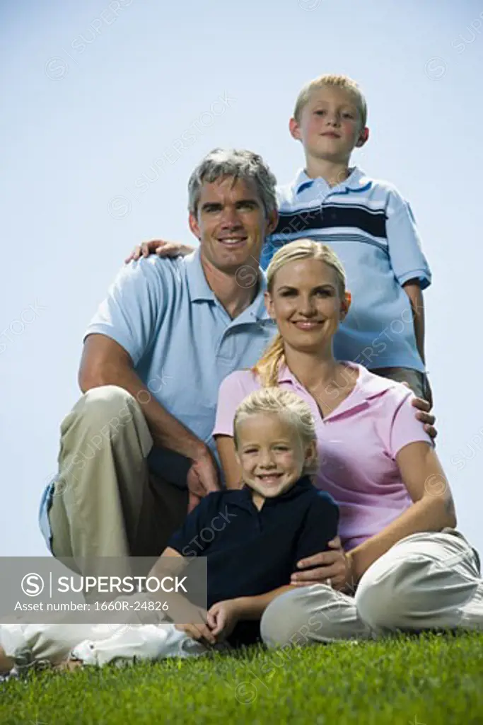 Low angle view of a family sitting on grass