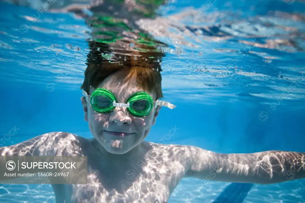 Boy swimming underwater in pool