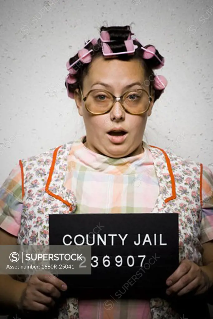 Mug shot of woman in curlers