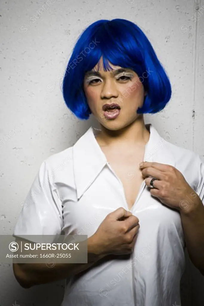 Man in blue wig and makeup flirting