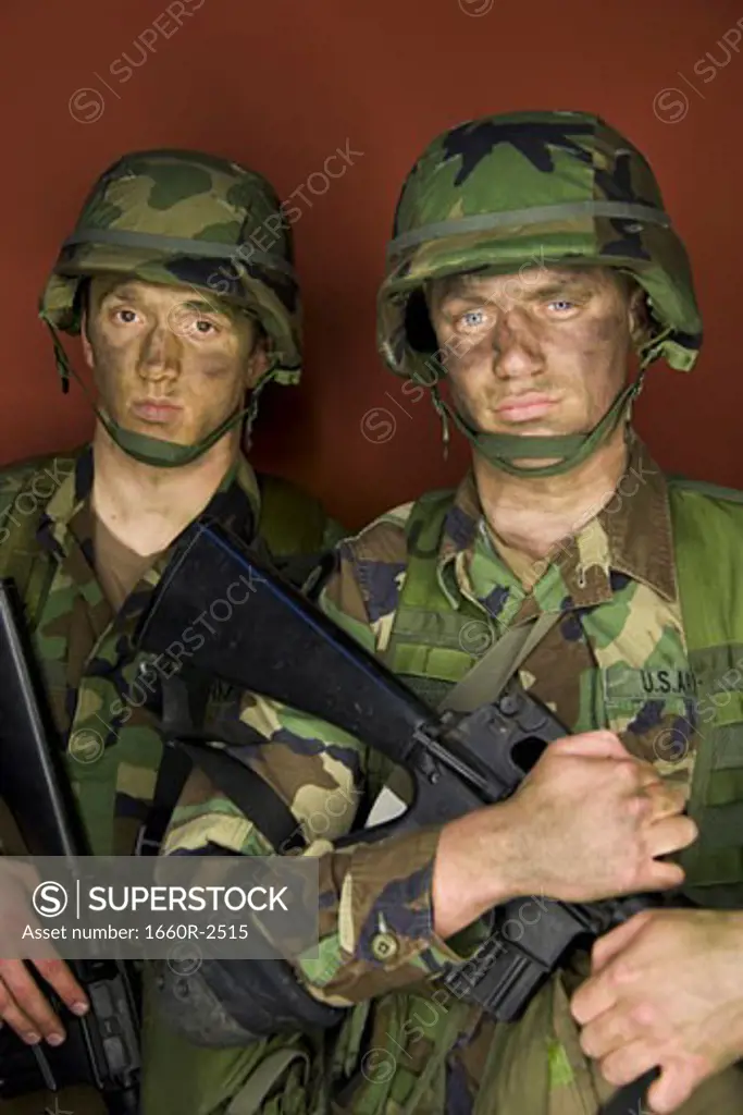 Portrait of two soldiers holding their rifles