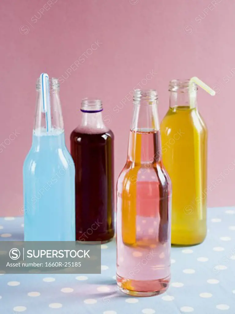 Four soda bottles with straws