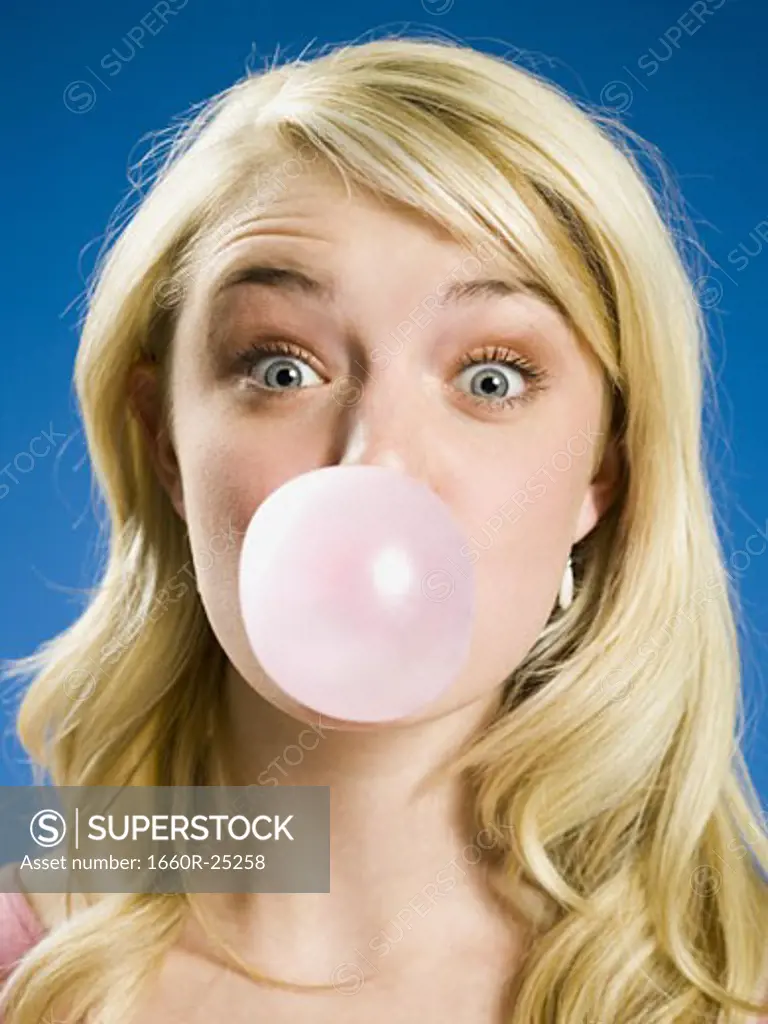 Girl blowing bubble and cross eyed