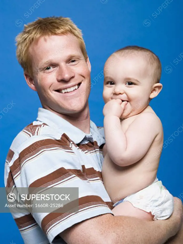 Man holding baby smiling