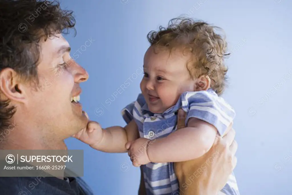 Man nose to nose with baby boy