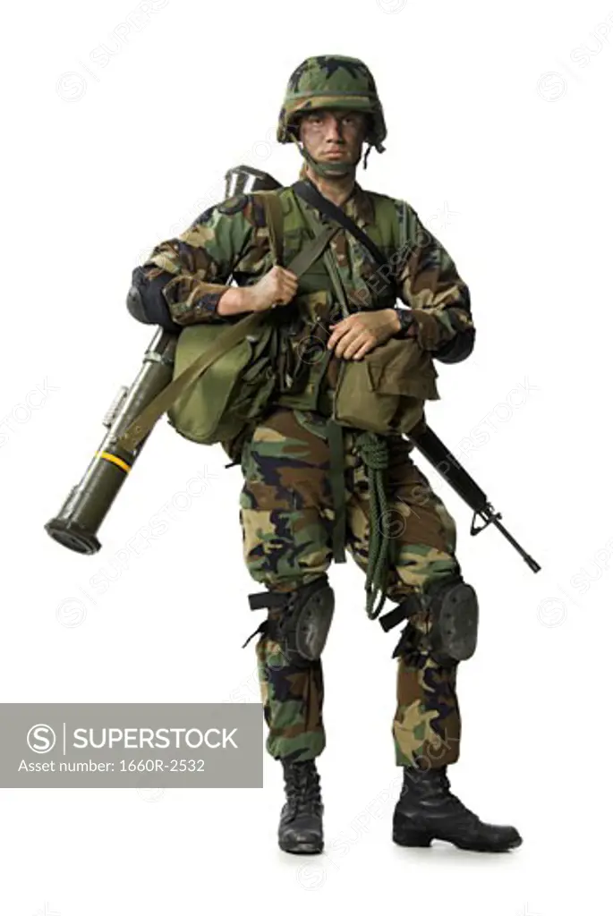 Portrait of a soldier carrying backpack and weapons