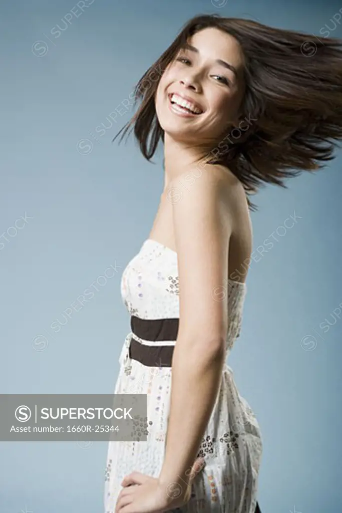 Woman tossing hair and smiling