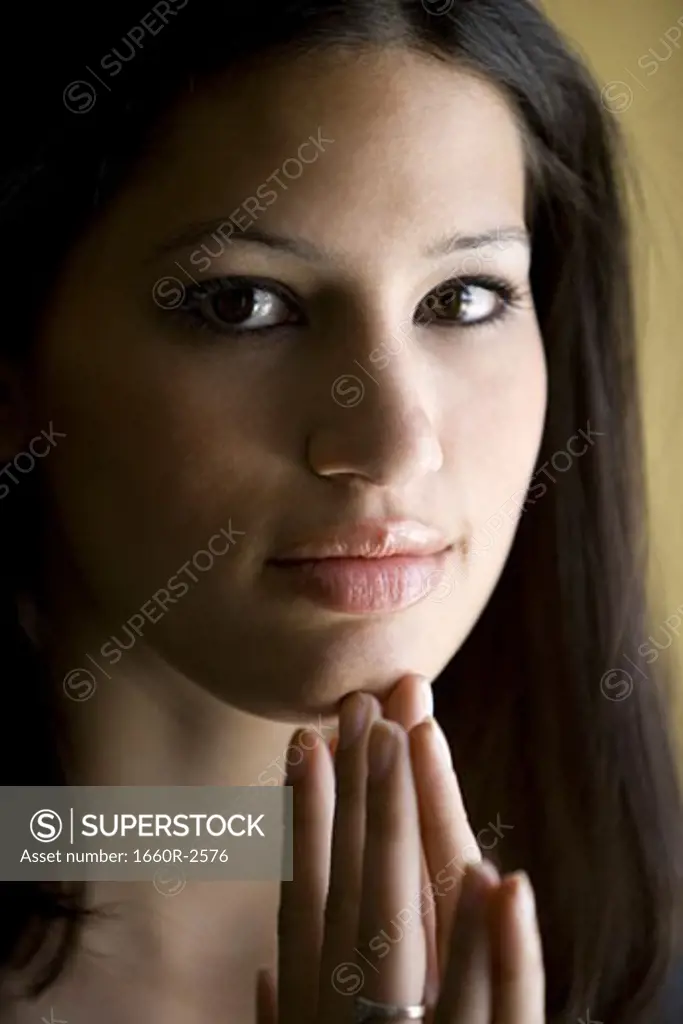 Portrait of a young woman with her hand on her chin