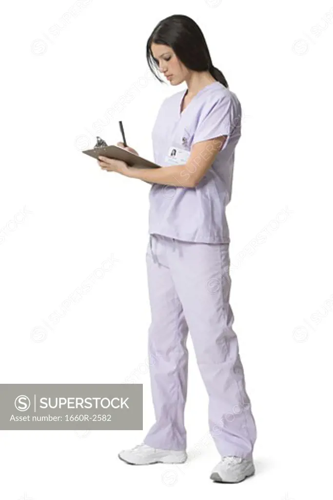 Side profile of a female nurse writing on a clipboard