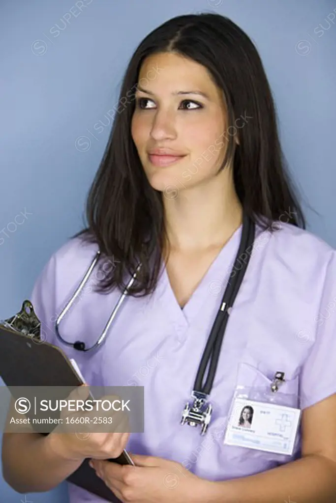 Close-up of a female nurse holding a clipboard