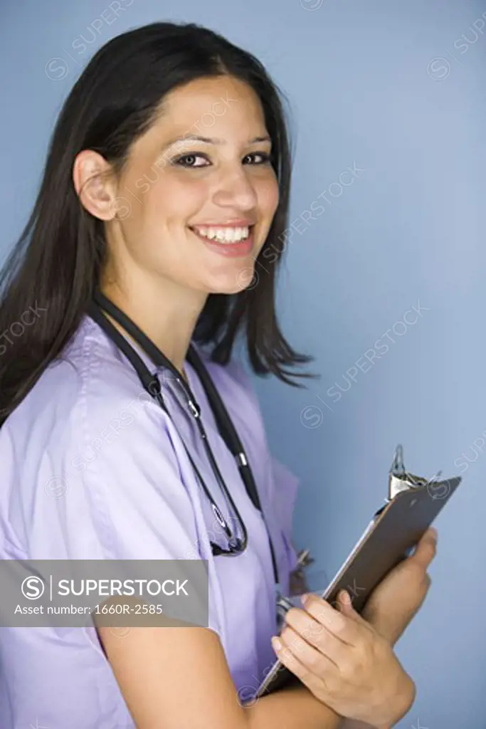 Side profile of a female nurse holding a clipboard